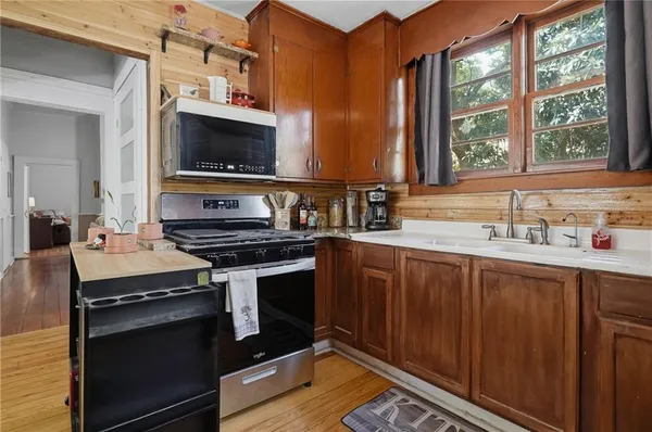 a kitchen with a sink stove and cabinets