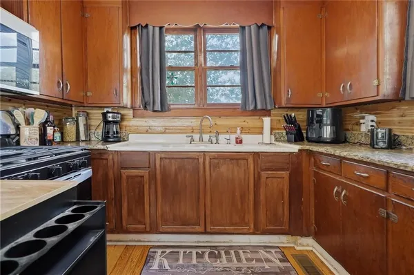 a kitchen with a sink cabinets and window