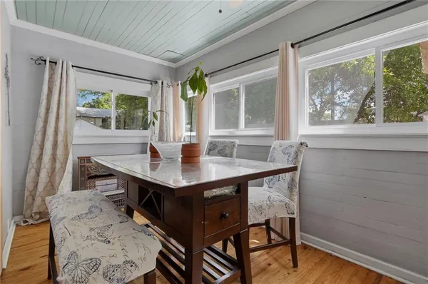 a view of a dining room with furniture and window
