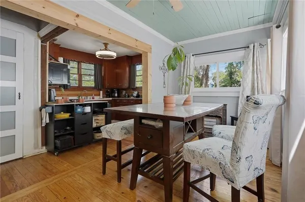 a view of a dining room with furniture window and wooden floor