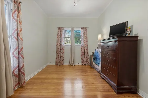 a bedroom with a bed and a television