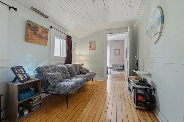 a living room with furniture a flat screen tv and a window