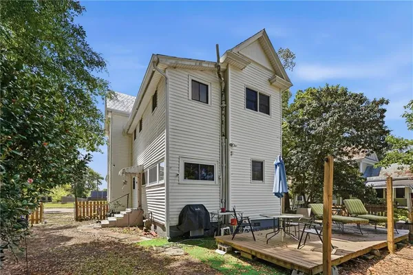 a view of a white house with a yard