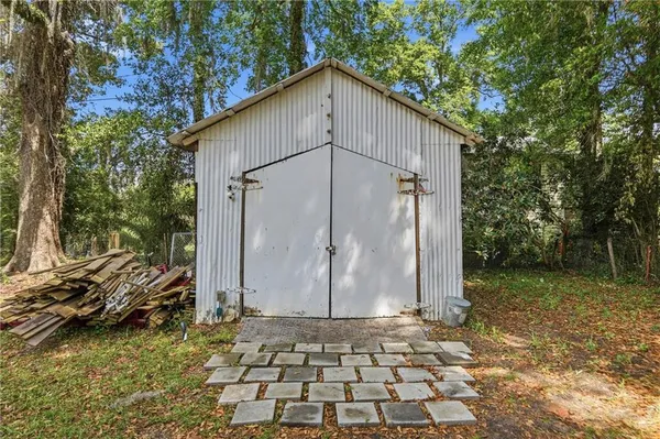 a view of a house with a yard and tree s