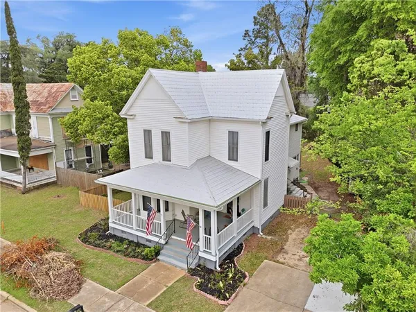 a view of a house with a yard and sitting area