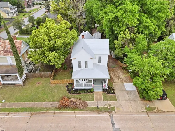 a aerial view of a house with roof deck front of house
