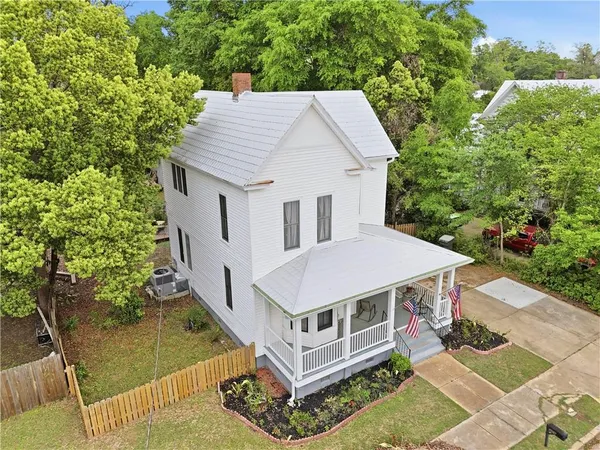 an aerial view of a house with yard swimming pool and outdoor seating