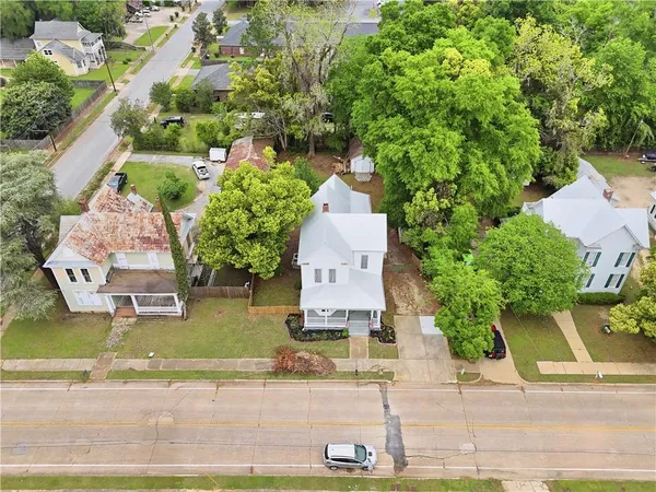 an aerial view of a house with a yard and garden