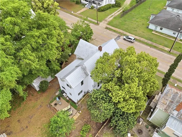 an aerial view of a house with a yard basket ball court and outdoor seating