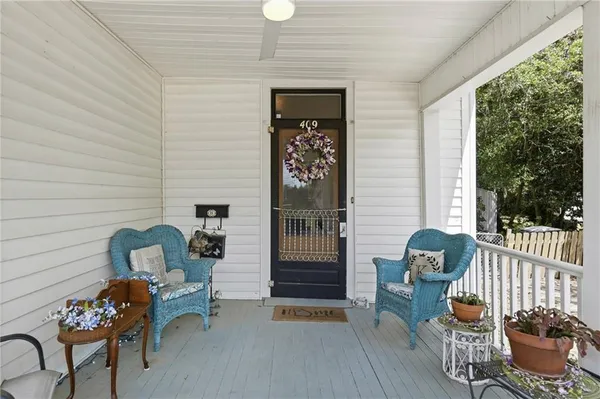 a view of a hallway with workspace and wooden floor