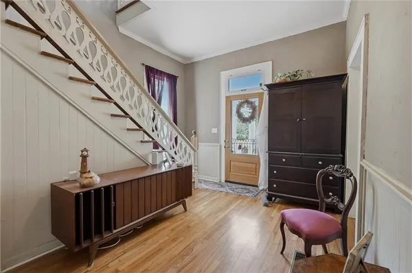 a bedroom with furniture and a flat screen tv