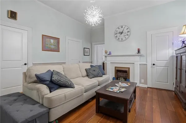 a living room with furniture a flat screen tv and a window