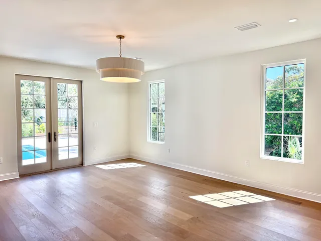 a view of a room with a window and wooden floor