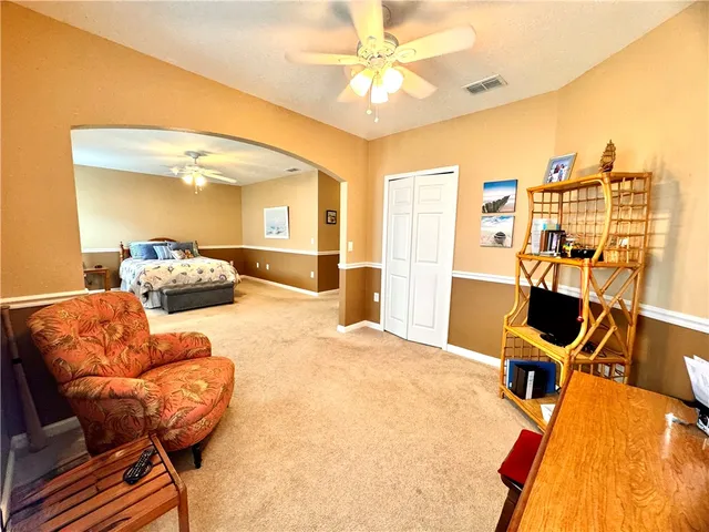 a bathroom with a granite countertop sink a bathtub a mirror and vanity