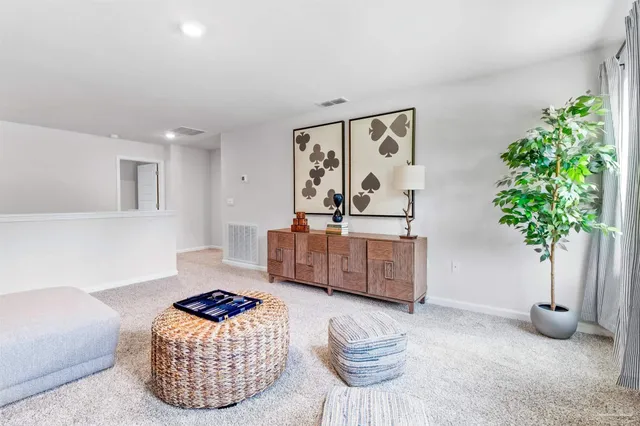 a living room with furniture and a potted plant