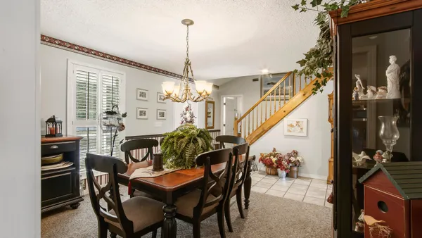a living room with furniture a flat screen tv and a large window