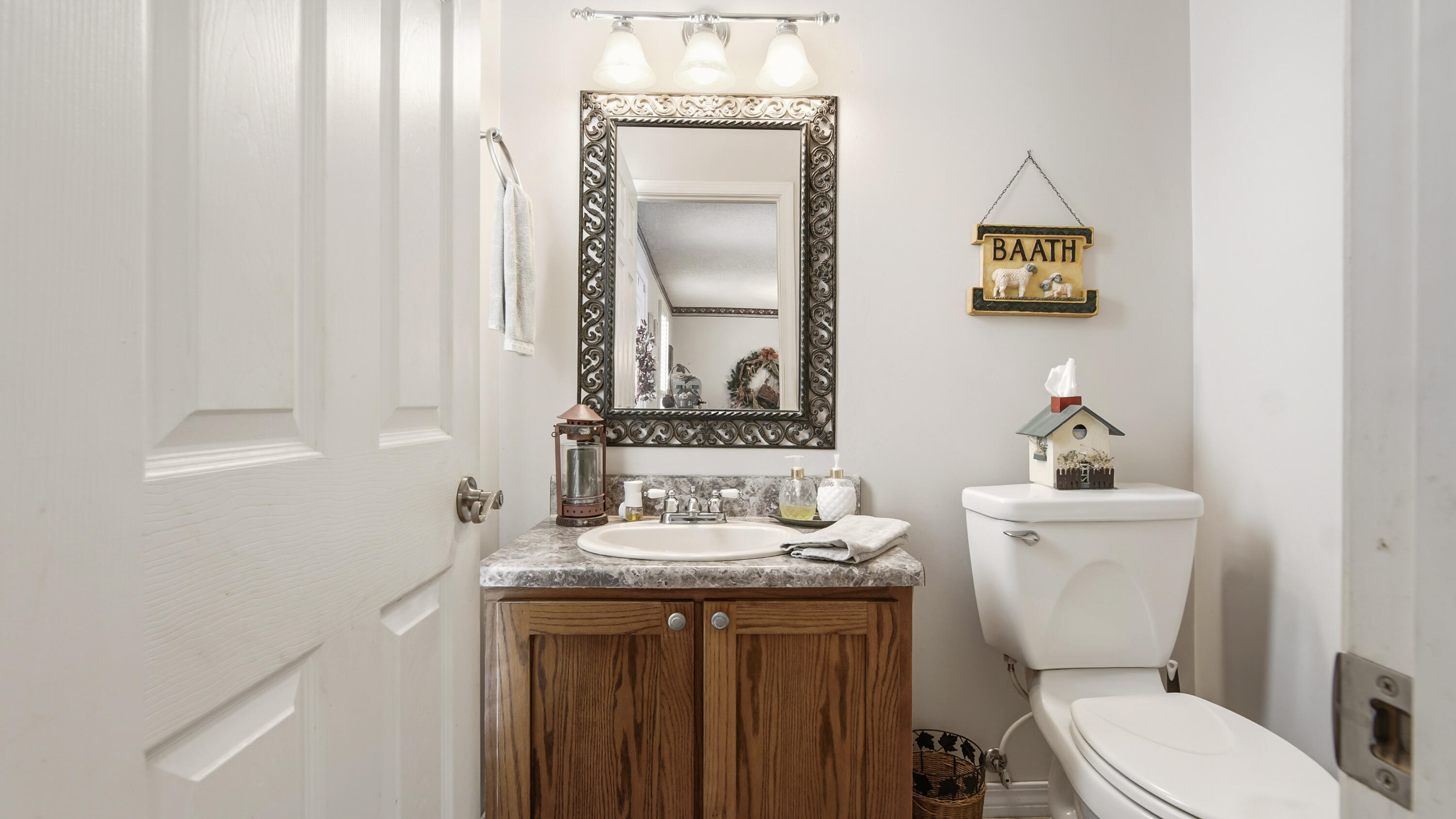 2272 Spring Lake Road DeFuniak Springs, FL 32433 - Photo 15 of 48 a bathroom with a toilet a sink and mirror