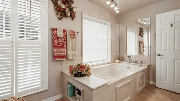 a bath room with a sink and a chandelier
