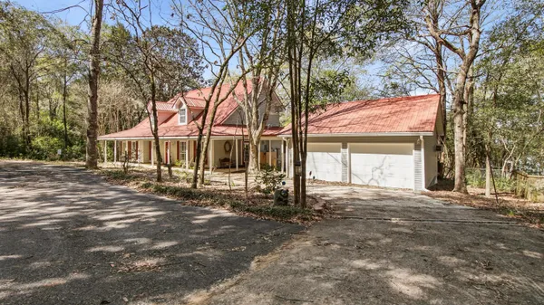a view of a house with a yard and tree s