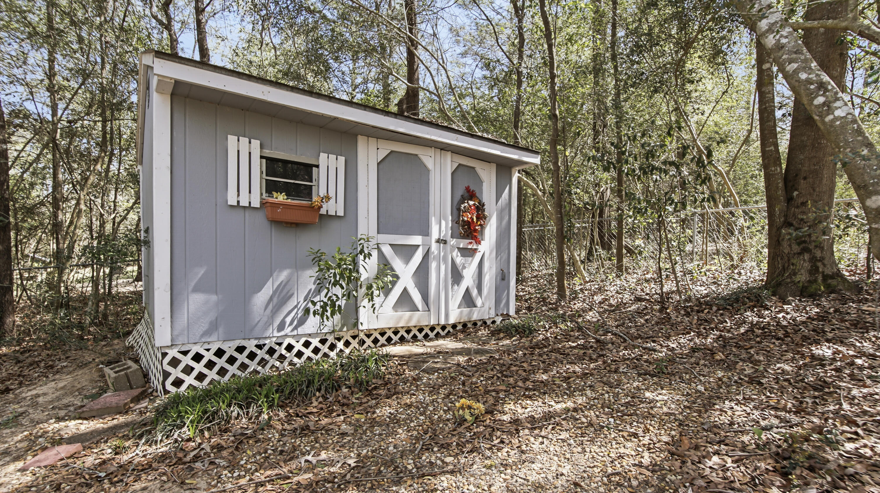 2272 Spring Lake Road DeFuniak Springs, FL 32433 - Photo 46 of 48 a front view of a house with garden