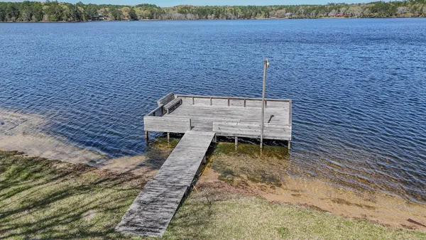a view of swimming pool and lake in the back