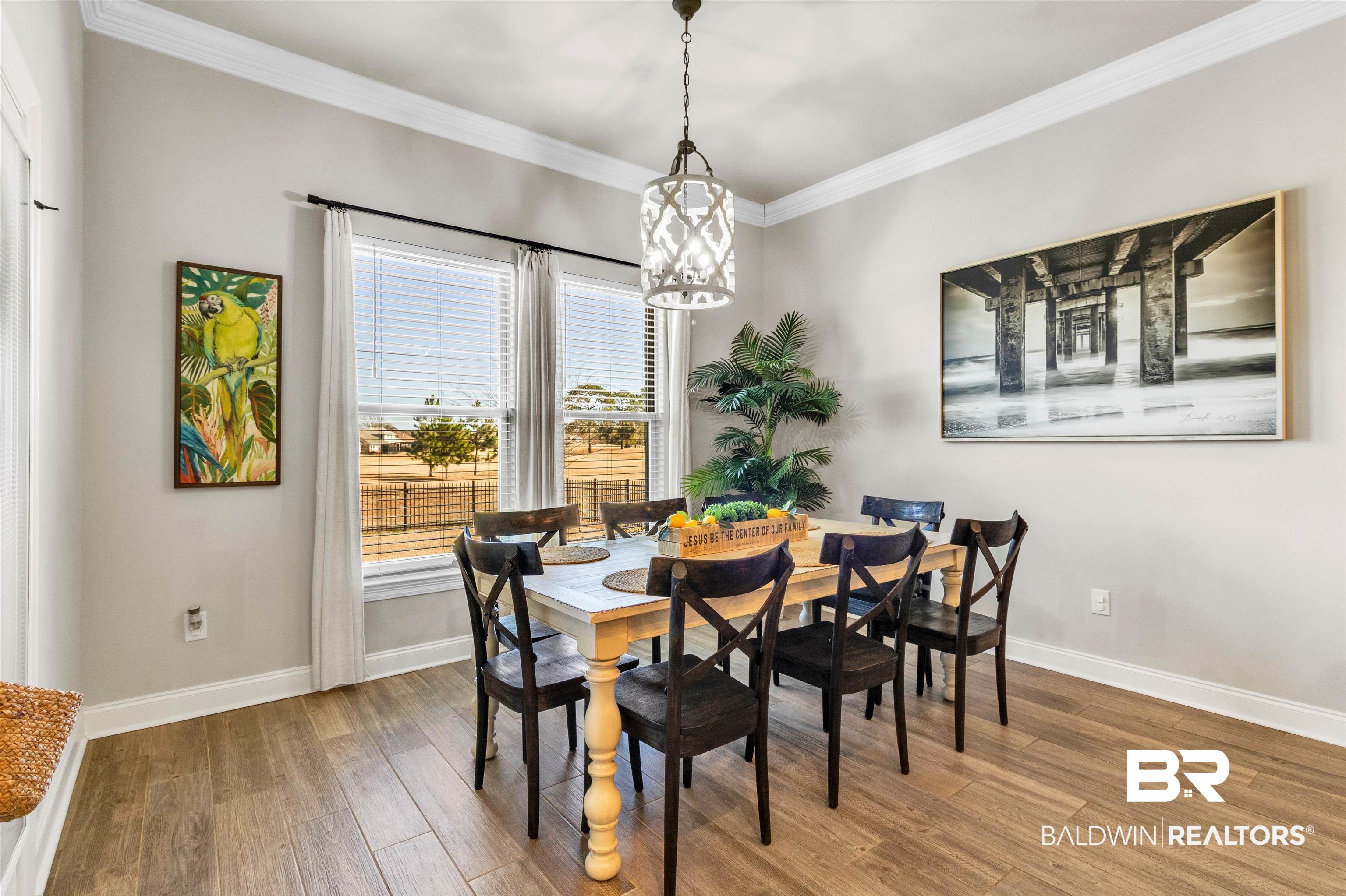 22531 Putter Lane Foley, AL 36535 - Photo 13 of 43 Dining space featuring light wood finished floors, ornamental molding, and suspended lighting