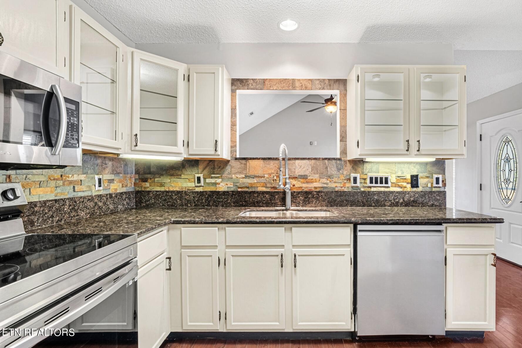 4348 Walnut Ridge Lane Knoxville, TN 37921 - Photo 11 of 31 a kitchen with granite countertop a sink a stove and cabinets