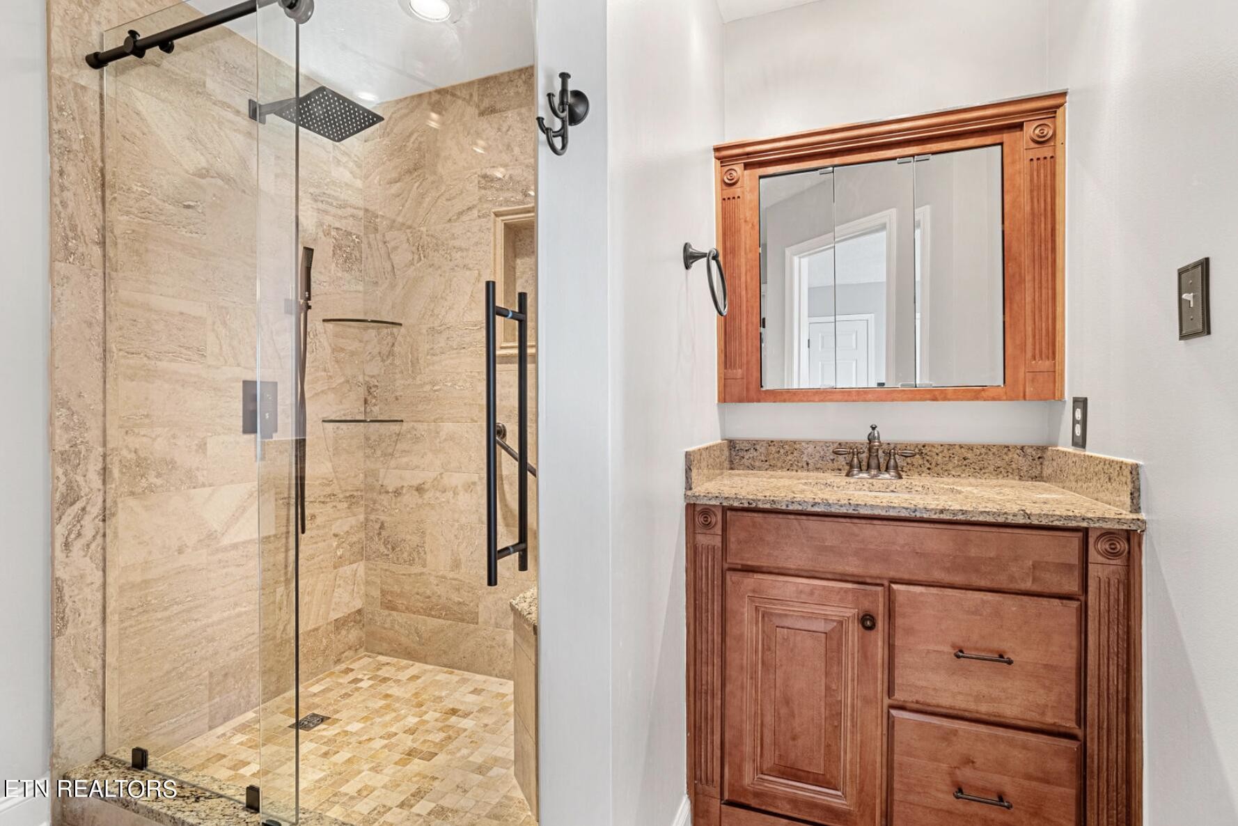 4348 Walnut Ridge Lane Knoxville, TN 37921 - Photo 20 of 31 a bathroom with a granite countertop sink a mirror and shower