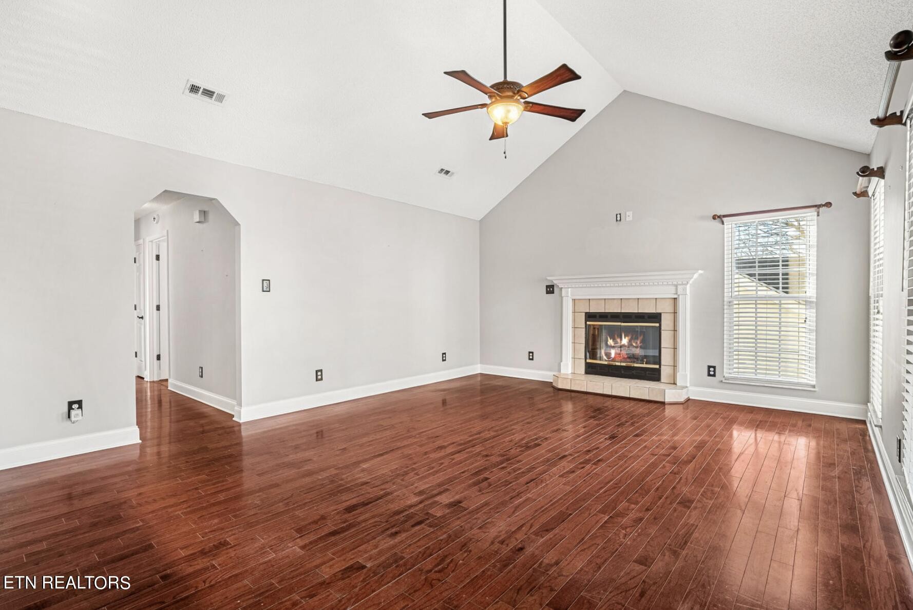 4348 Walnut Ridge Lane Knoxville, TN 37921 - Photo 4 of 31 an empty room with wooden floor fan and windows