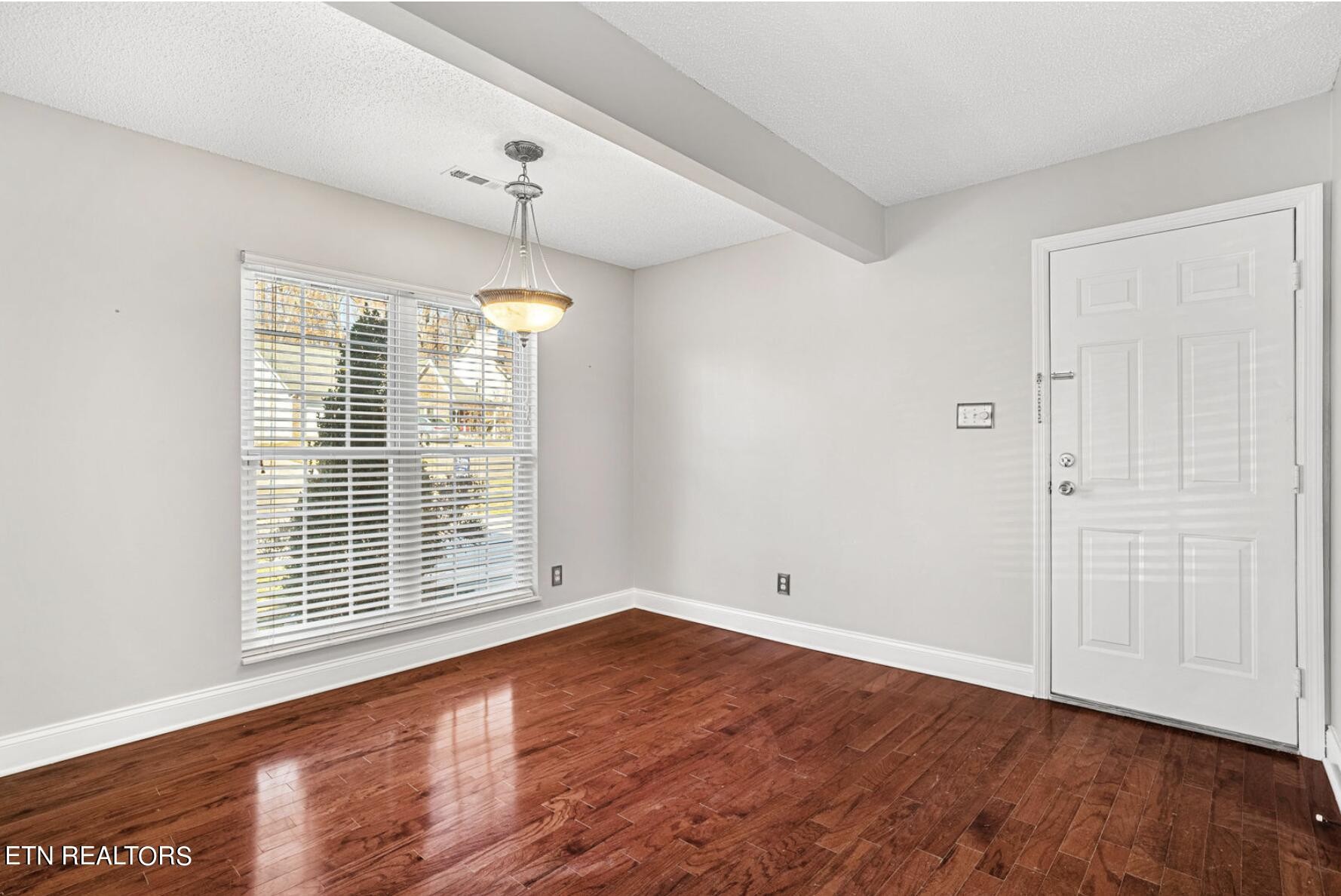 4348 Walnut Ridge Lane Knoxville, TN 37921 - Photo 6 of 31 a view of an empty room with wooden floor and a window