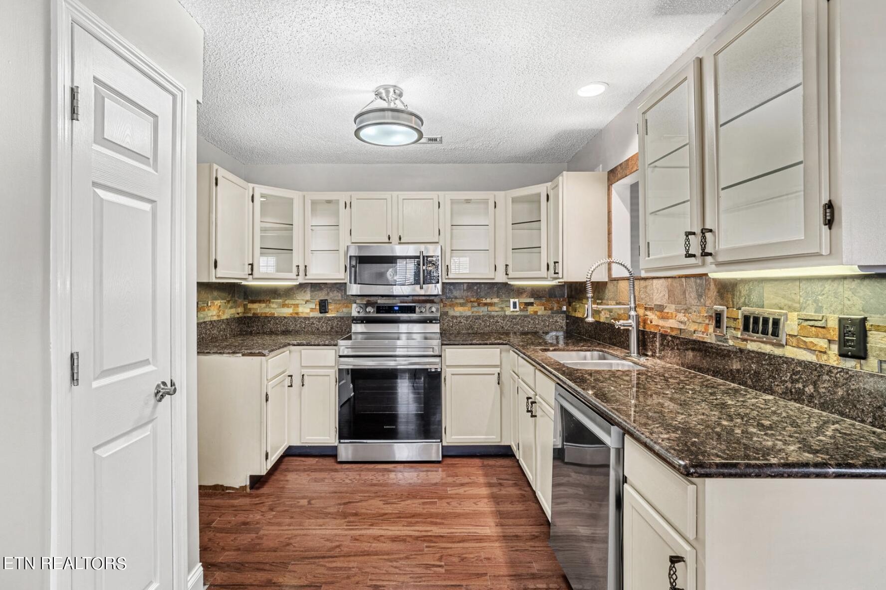 4348 Walnut Ridge Lane Knoxville, TN 37921 - Photo 8 of 31 a kitchen with stainless steel appliances granite countertop a stove sink and cabinets