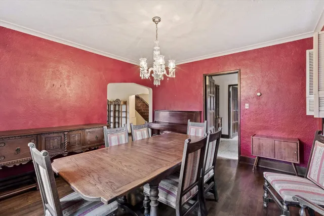 a view of a dining room with furniture and chandelier