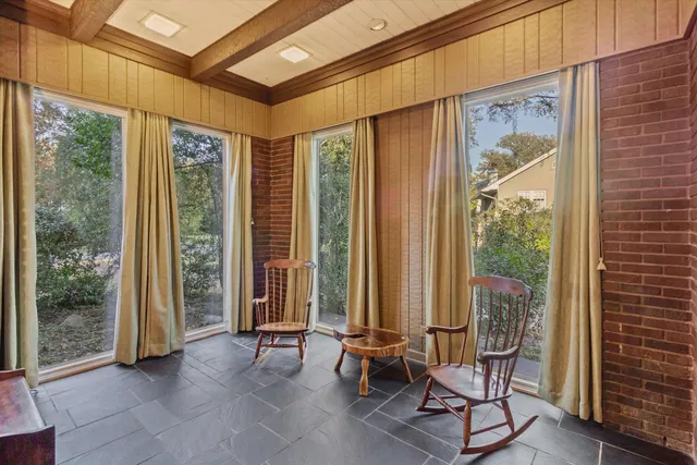 a view of a room with furniture and floor to ceiling windows