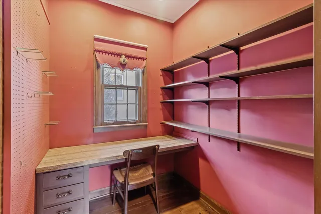 a dining room with a wooden table and chairs
