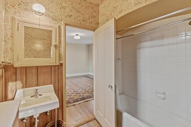 a bathroom with a sink vanity and tub