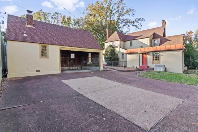 a front view of a house with a yard and a garage