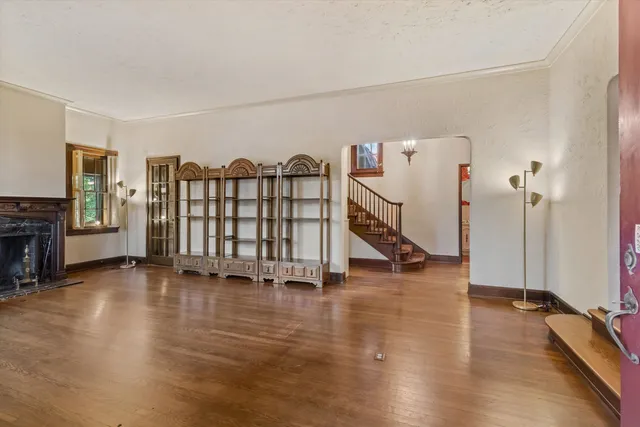 a view of a livingroom with wooden floor and stairs