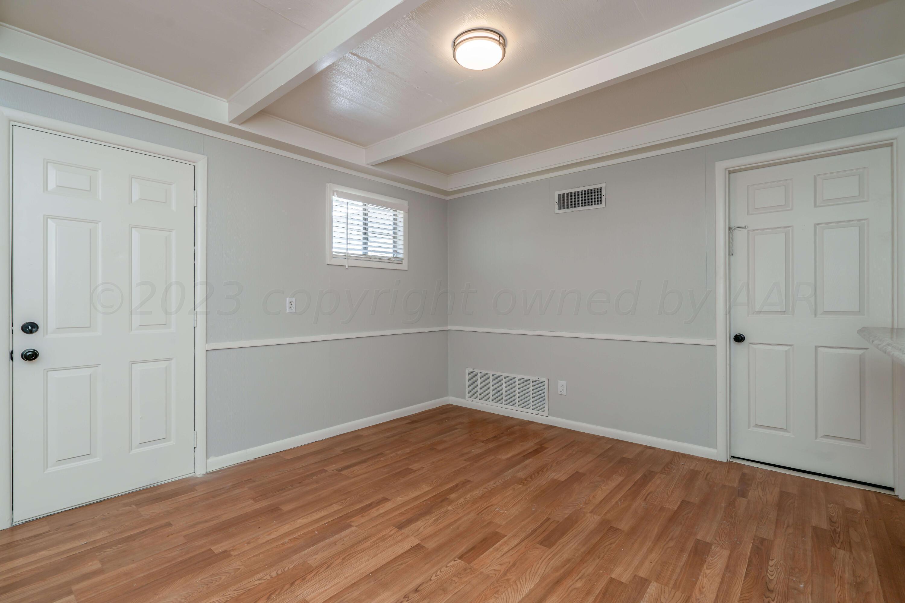 4306 Parker Street Amarillo, TX 79110 - Photo 12 of 29 a view of a room with wooden floor and white walls