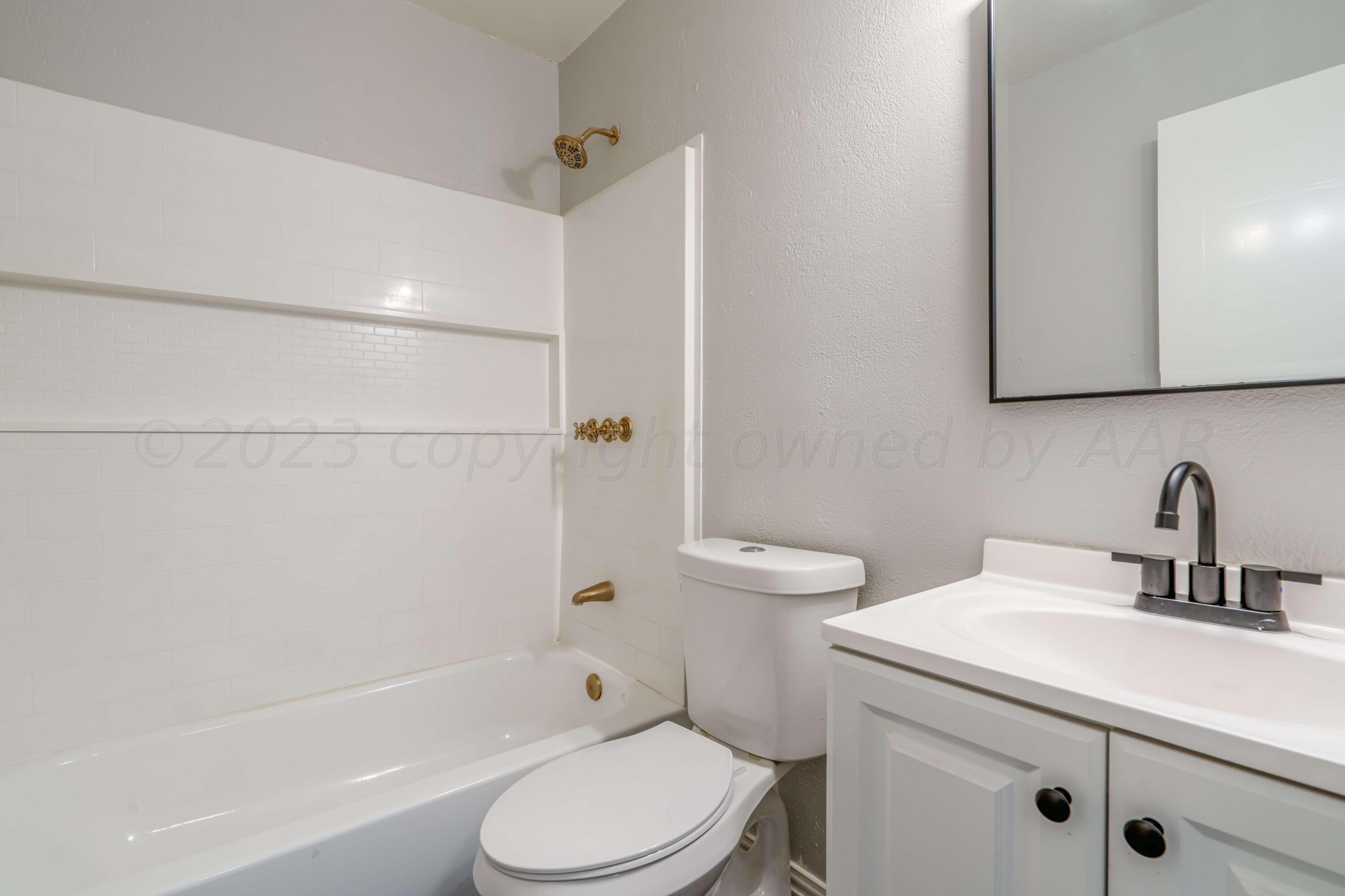 4306 Parker Street Amarillo, TX 79110 - Photo 17 of 29 a bathroom with a sink a toilet and shower
