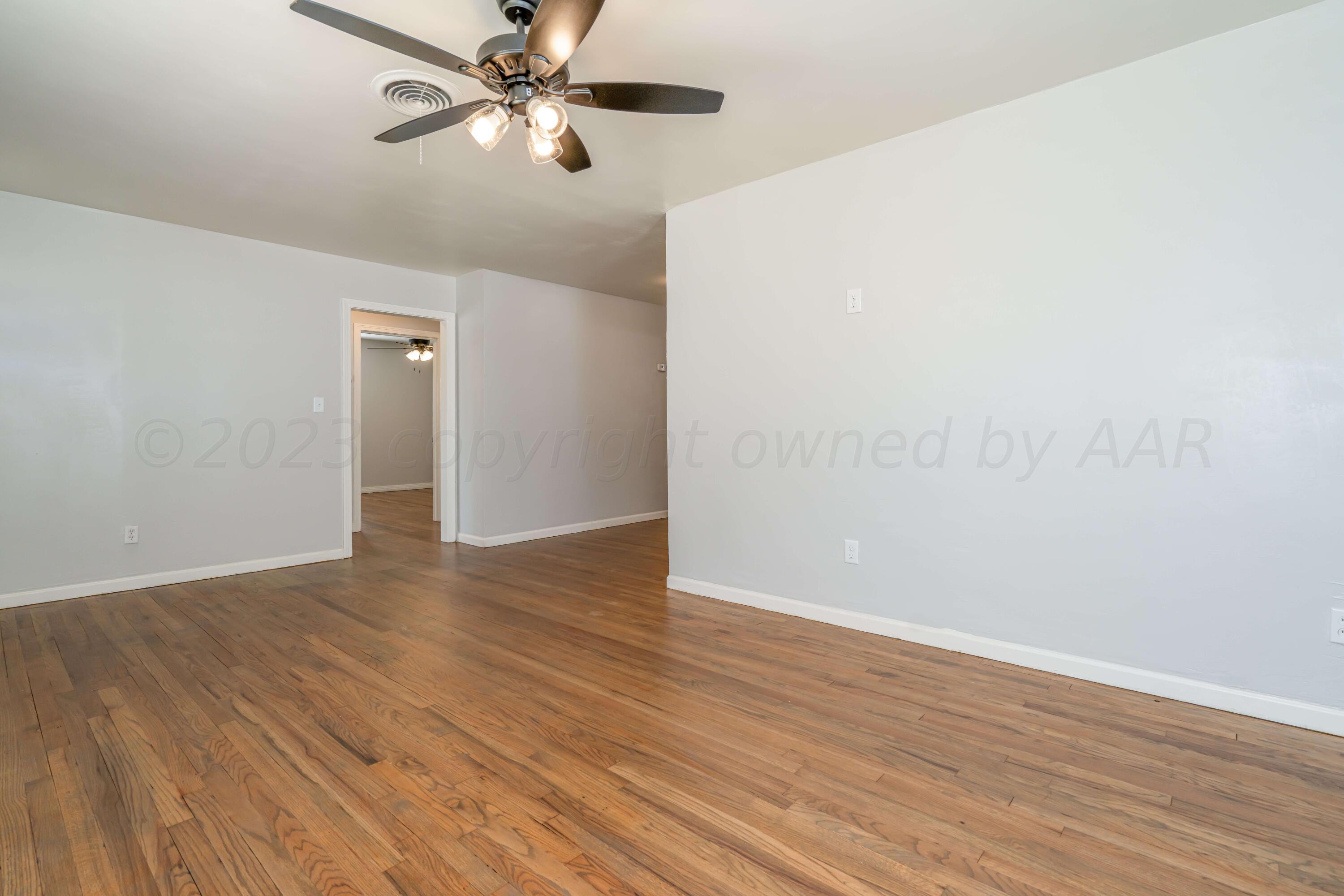 4306 Parker Street Amarillo, TX 79110 - Photo 4 of 29 a view of an empty room with wooden floor