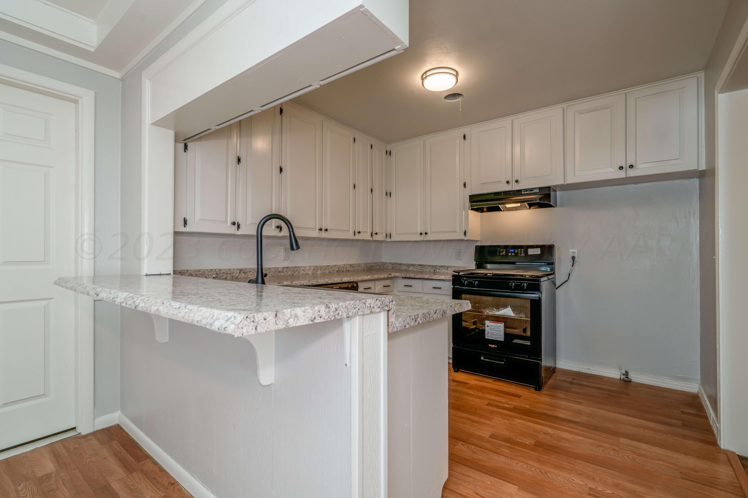4306 Parker Street Amarillo, TX 79110 - Photo 10 of 29 a kitchen with stainless steel appliances granite countertop a sink stove and refrigerator
