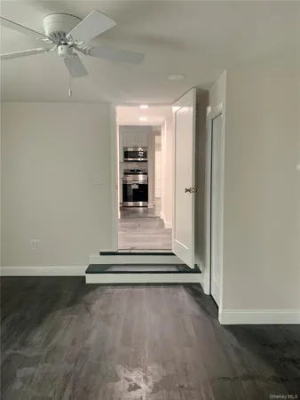 a view of an empty room with a fireplace