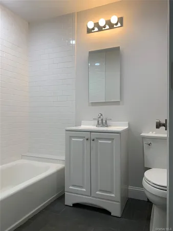 a bathroom with a sink a toilet and bathtub