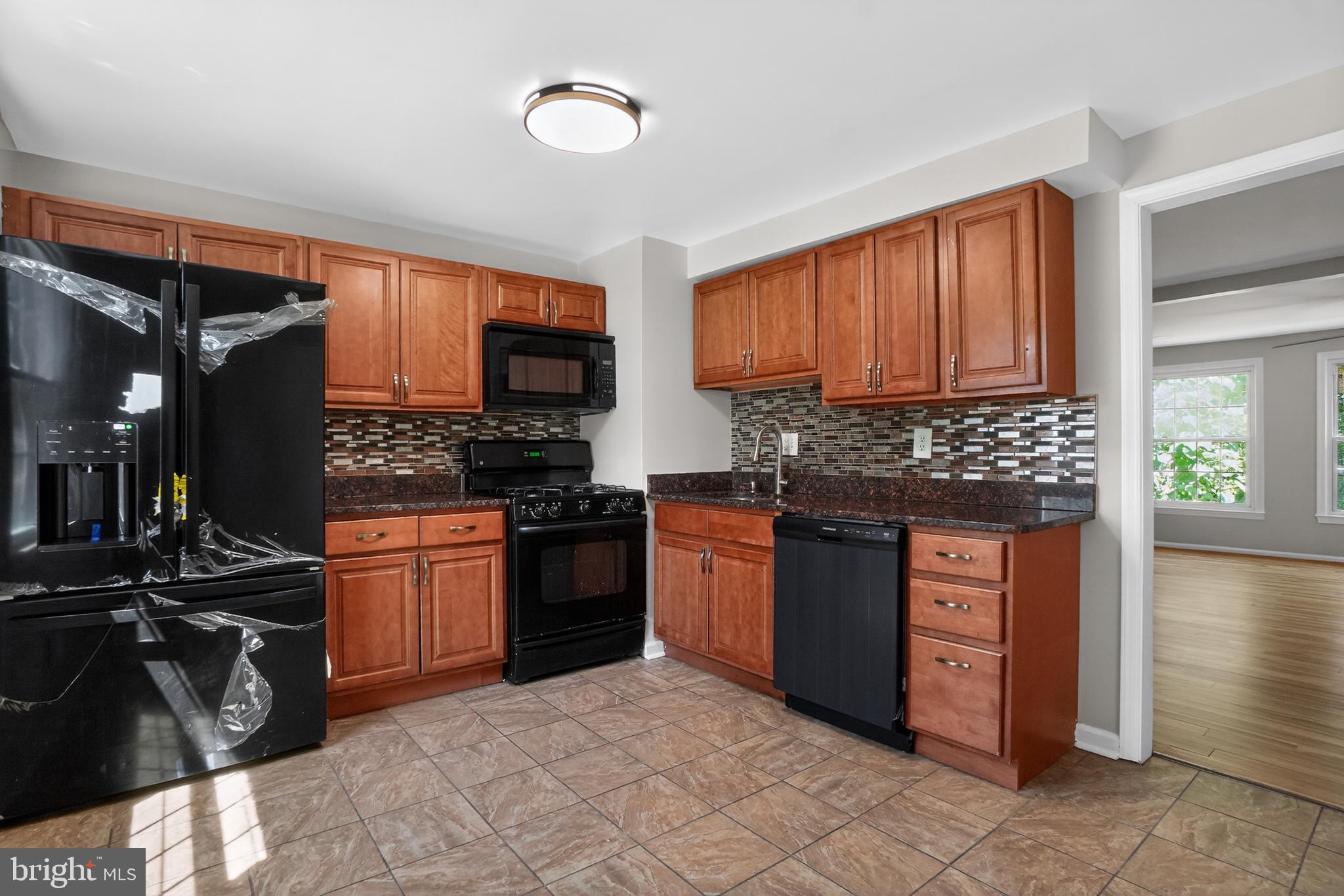 1232 Palmer Road, Unit 111 Fort Washington, MD 20744 - Photo 10 of 45 a kitchen with stainless steel appliances granite countertop a stove top oven a sink and dishwasher