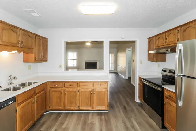 a kitchen with a sink appliances and cabinets