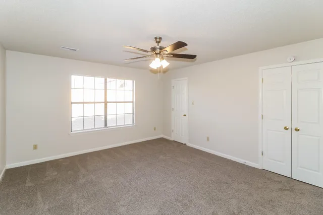 a view of an empty room with a window