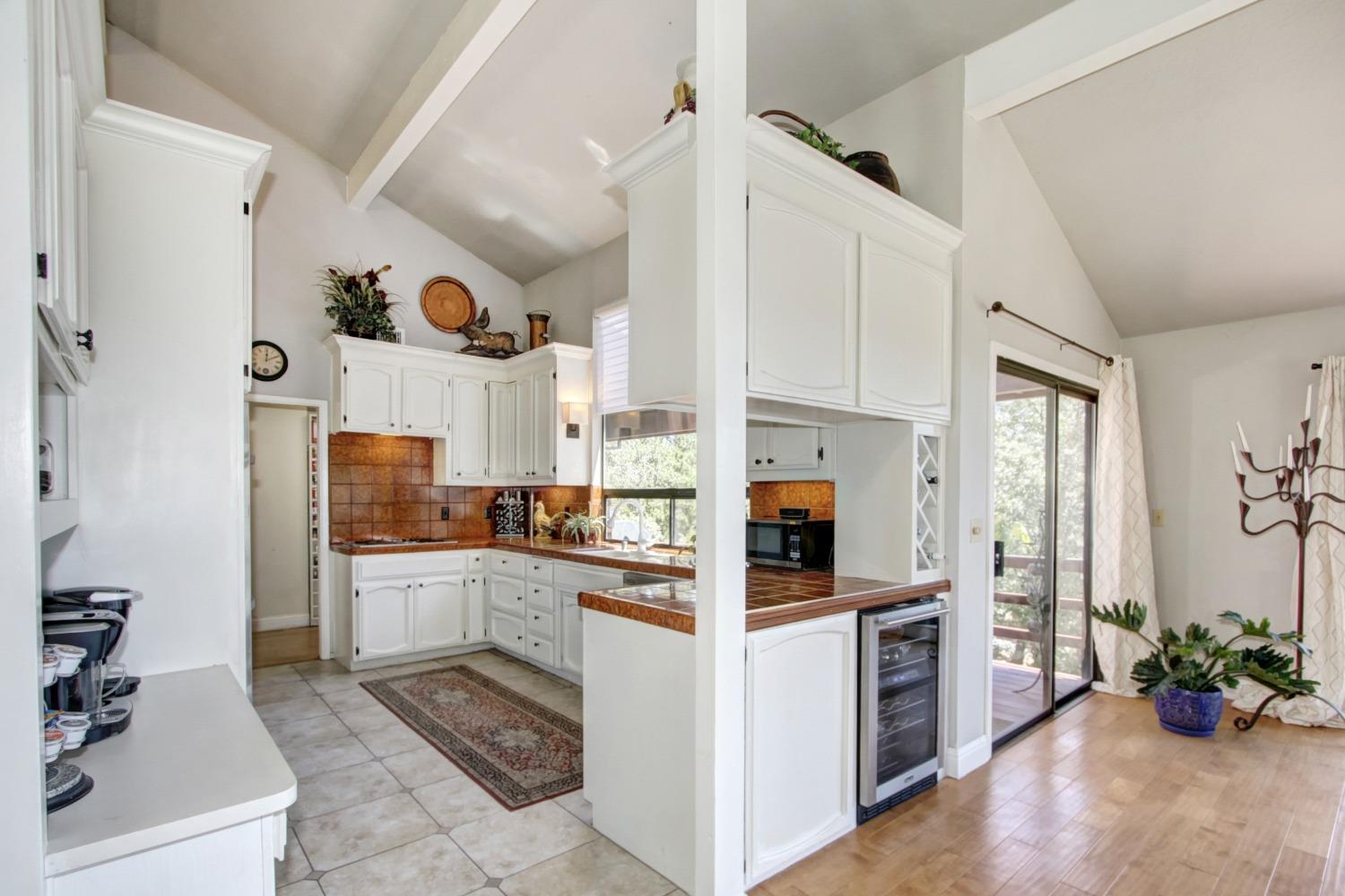18119 Norlene Way Grass Valley, CA 95949 - Photo 21 of 93 a kitchen with white cabinets and appliances