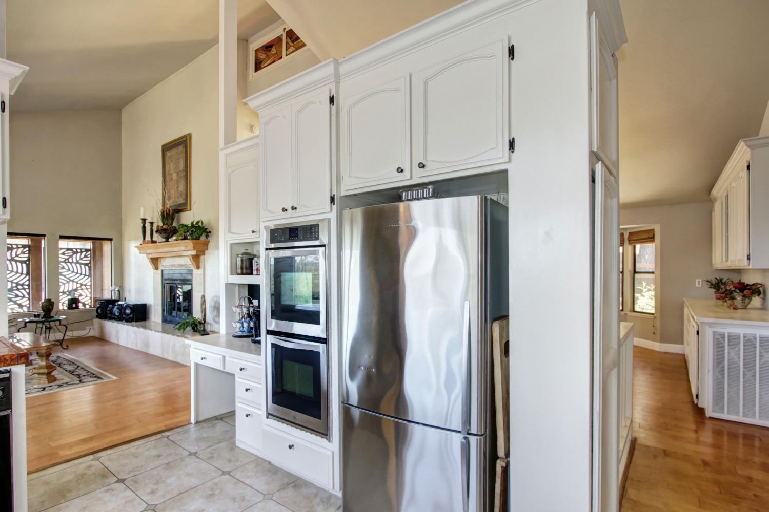 18119 Norlene Way Grass Valley, CA 95949 - Photo 28 of 93 a kitchen with stainless steel appliances granite countertop a refrigerator and a sink