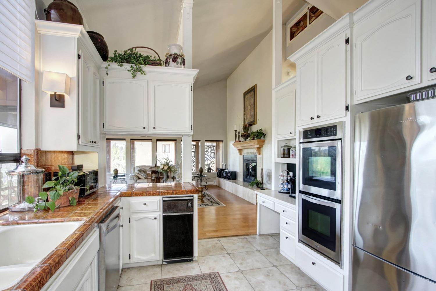 18119 Norlene Way Grass Valley, CA 95949 - Photo 29 of 93 a kitchen with white cabinets and stainless steel appliances