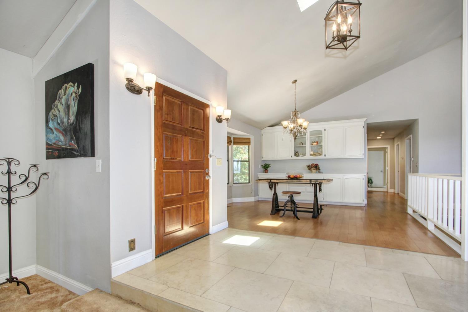18119 Norlene Way Grass Valley, CA 95949 - Photo 41 of 93 a living room with furniture a dining table and paintings on the wall